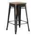 A black Lancaster Table & Seating backless counter height stool with a gray wood seat.