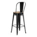 A Lancaster Table & Seating black metal bar stool with a gray wood seat.