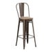 A brown metal Lancaster Table & Seating bar stool with a gray wood seat.
