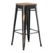 A Lancaster Table & Seating black metal barstool with a gray wood seat.