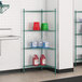 A green metal Regency wire shelving unit with containers and buckets.