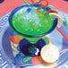 A green drink with straws in a Hoshizaki flake ice filled glass.