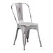 A white metal Lancaster Table & Seating cafe chair with a brown seat.