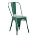 A green metal chair with a green seat.