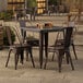 A Lancaster Table & Seating outdoor patio table with four chairs.