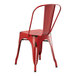 A Lancaster Table & Seating red metal outdoor table with 4 red metal chairs.