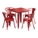 A Lancaster Table & Seating distressed ruby red metal table and chairs set.