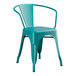 A teal metal arm chair.