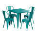 A teal square Lancaster Table & Seating outdoor table with chairs around it.