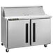 A silver Traulsen refrigerated sandwich prep table on wheels.