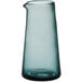 An Acopa Pangea clear glass carafe with a blue base and a curved neck.