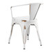 A white metal Lancaster Table & Seating chair with a wooden seat.