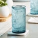 close-up of a white vase and a blue glass