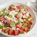 A bowl of watermelon salad with cucumbers and V&V Supremo Queso Fresco cheese.