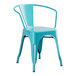 A turquoise metal arm chair.