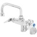 A silver T&S wall mount pantry faucet with blue handles.