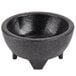 A black polypropylene molcajete bowl with three legs.