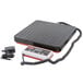 A black Rubbermaid electronic receiving scale with a cord.