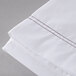 A white Oxford Superblend XL Queen flat sheet with brown stitching.