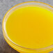 A bowl of Les Vergers Boiron Corsican Clementine fruit puree on a counter.