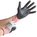 A person wearing Cordova Machinist work gloves with black foam nitrile palms.