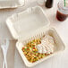 A Footprint Bagasse take-out container filled with food.