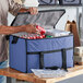 A man putting cans in a Choice navy insulated cooler bag.