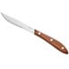 An Acopa steak knife with a natural Pakkawood handle.