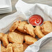 A basket filled with Beleaf Plant-Based Vegan Chicken nuggets with ketchup on a table.