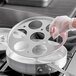 a hand holding a circular object