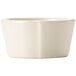 A Libbey Farmhouse ivory melamine sauce cup with a handle.