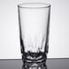 An Arcoroc clear glass tumbler with a patterned design on a table.