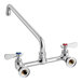 A silver Regency wall mount faucet with red and blue knobs.