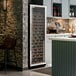 A tall, single temperature commercial wine cooler with a full glass door, filled with wine bottles.