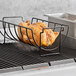 A chicken cooking on an Outset non-stick roast and rib rack on a grill.