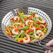 Outset stainless steel grill skillet filled with shrimp and vegetables cooking on a grill.