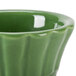 A green ceramic CAC China floral ramekin with a wavy design.