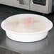 A white Pactiv plastic container with a lid on a counter.