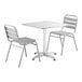 A Lancaster Table & Seating chrome square table with a white top and 2 silver chairs.