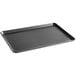 A black rectangular Baker's Mark bun/sheet pan with a semi-curled rim.