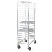 A silver metal Regency side load sheet pan rack with shelves on wheels.