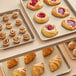 A Baker's Mark non-stick aluminum tray of pastries with a red jelly inside.