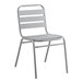 A gray metal Lancaster Table & Seating chair with metal legs and a white seat.