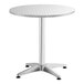 A Lancaster Table & Seating round outdoor table with a metal base.