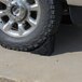 A tire sitting on a Vestil reinforced rubber wheel chock.