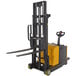 A yellow and black Vestil counter-balanced forklift with adjustable forks.