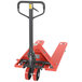 A red Vestil hand pallet truck with black handle.