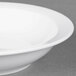 An Arcoroc Daring white porcelain fruit dish with a white rim.