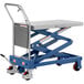 A blue and silver Vestil hydraulic lift cart on a table.