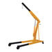 A yellow and black Vestil hydraulic crane with a black handle.